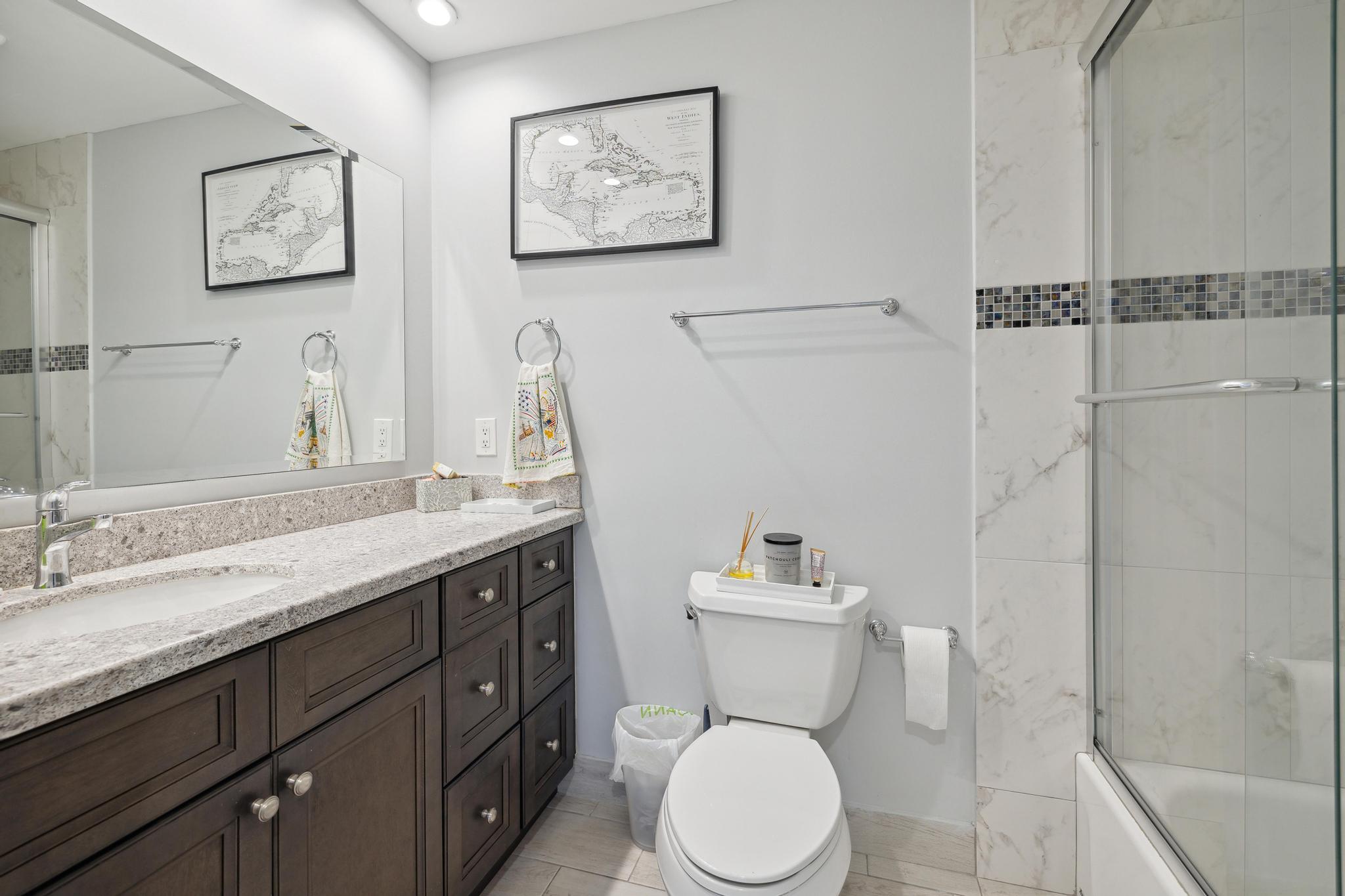 5131 Nesting Way, Unit D Delray Beach, FL 33484 - Photo 13 of 24 a bathroom with a granite countertop toilet sink and a mirror