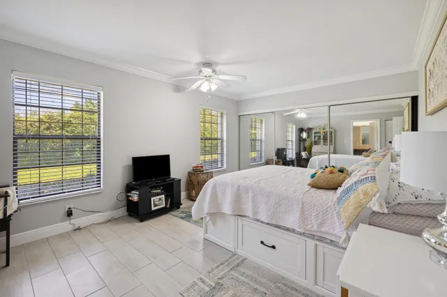 a bedroom with a bed and a television