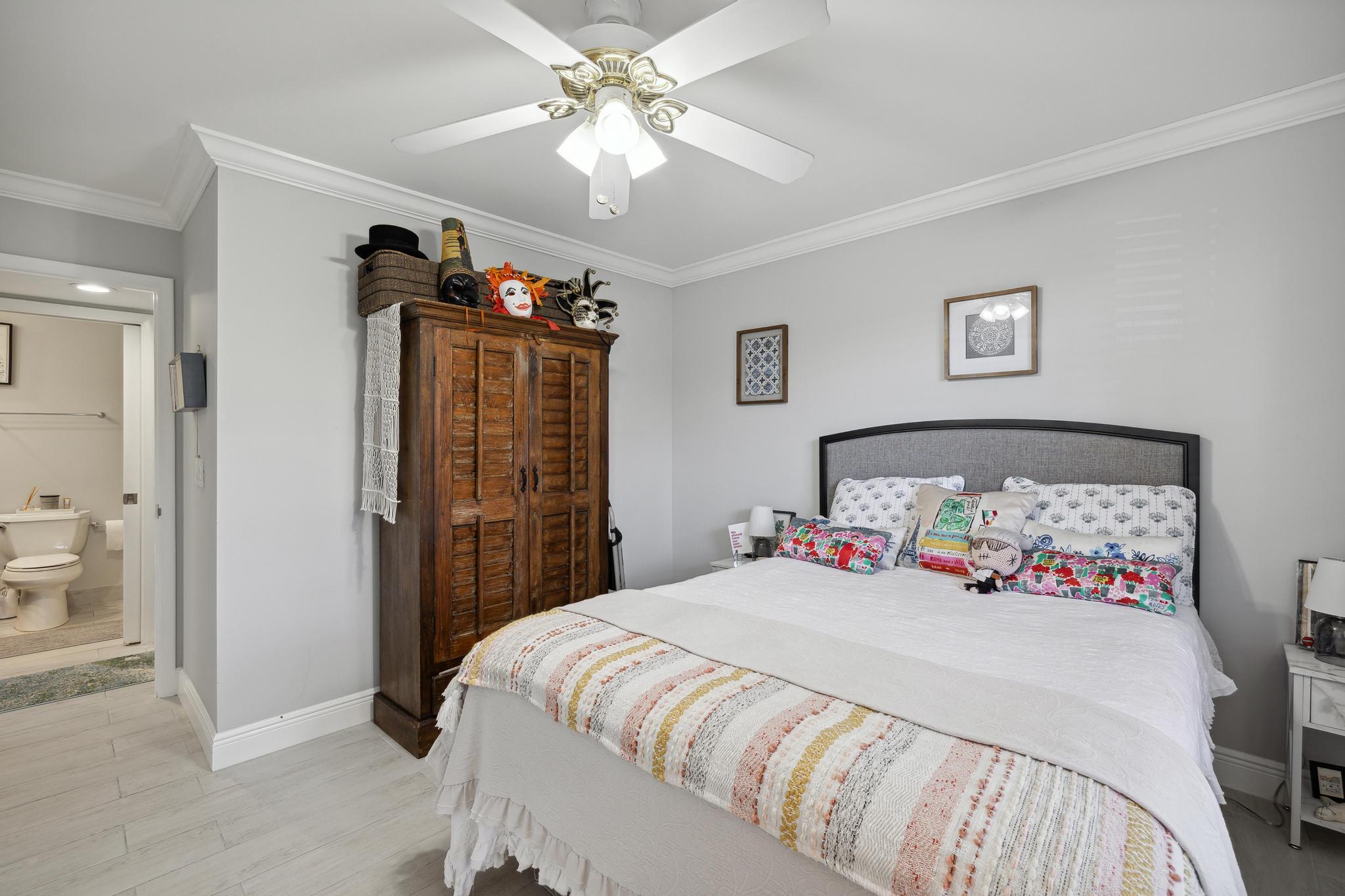 5131 Nesting Way, Unit D Delray Beach, FL 33484 - Photo 18 of 24 a bedroom with a bed dresser and a window