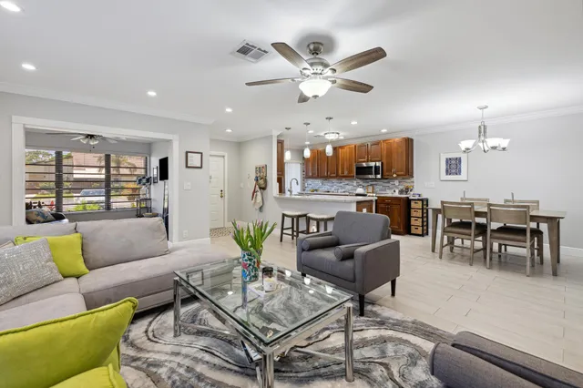 a living room with furniture and kitchen view