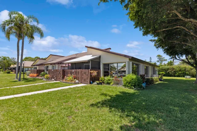 a front view of house with yard and outdoor seating