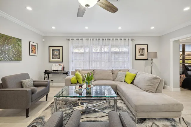 a living room with furniture and painting on the wall
