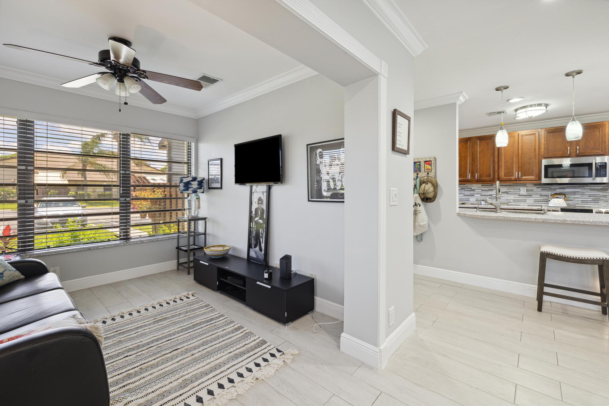 5131 Nesting Way, Unit D Delray Beach, FL 33484 - Photo 5 of 24 a living room with furniture and a flat screen tv