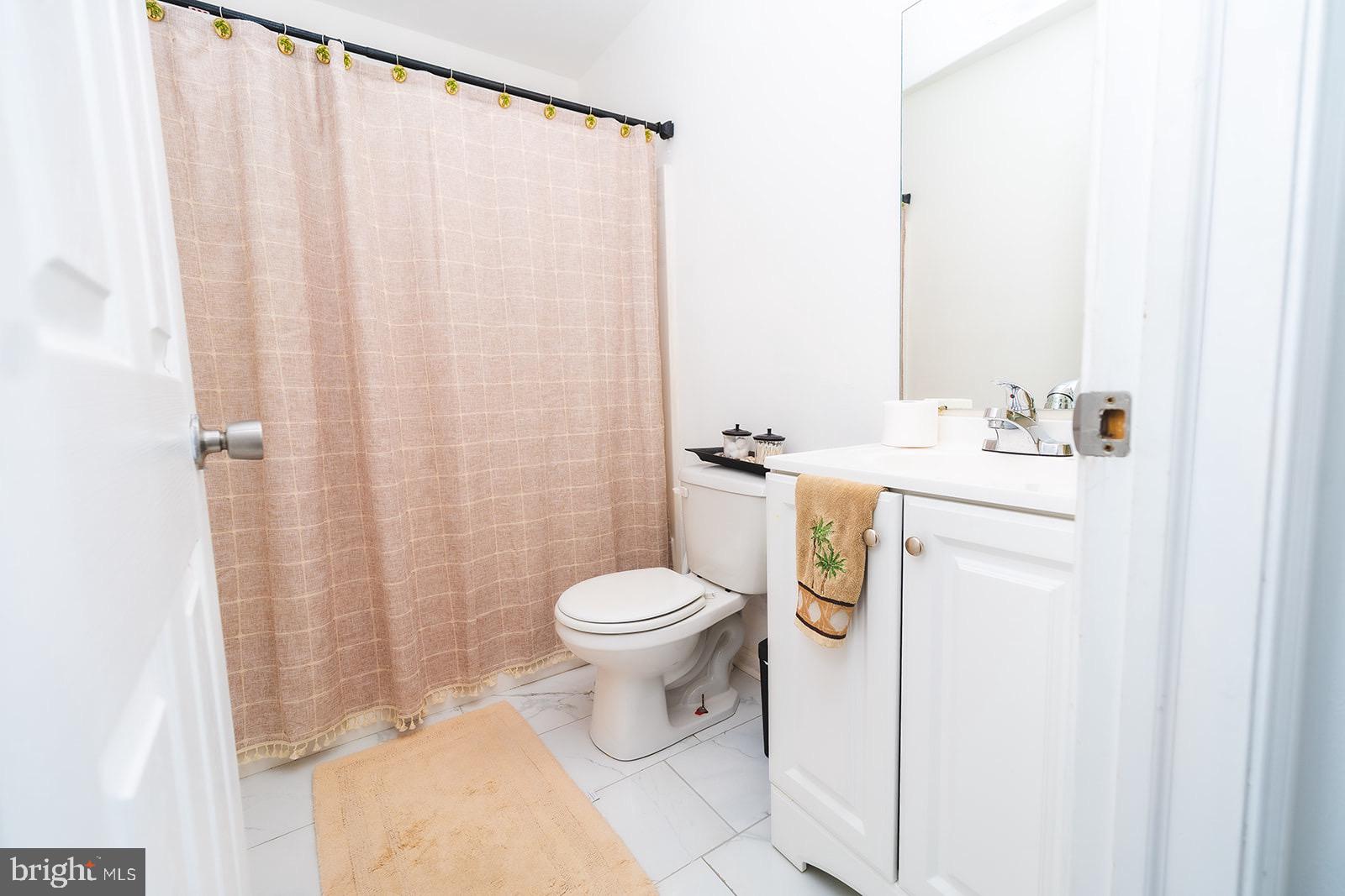 3 Union Street Marcus Hook, PA 19061 - Photo 11 of 23 a white toilet sitting next to a bathroom sink