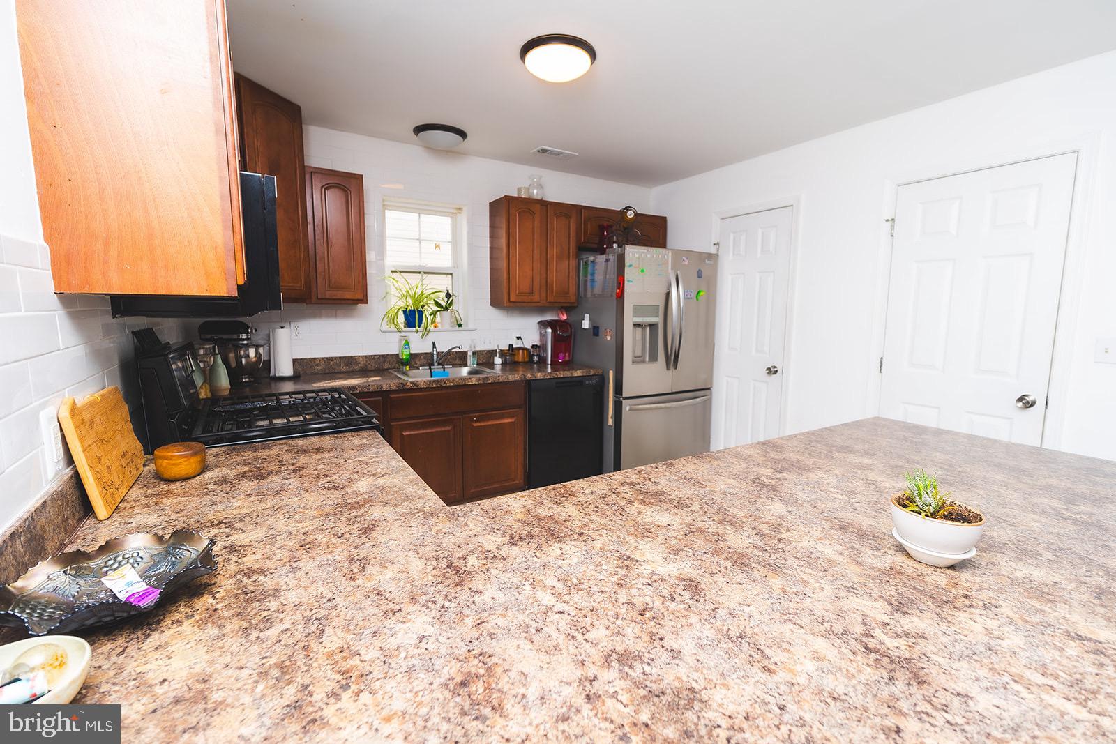 3 Union Street Marcus Hook, PA 19061 - Photo 4 of 23 a kitchen with granite countertop a sink stainless steel appliances and cabinets