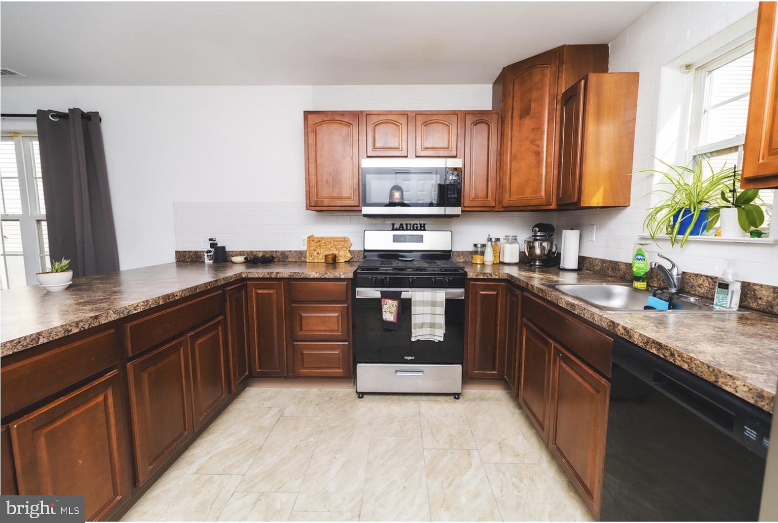 3 Union Street Marcus Hook, PA 19061 - Photo 8 of 23 a kitchen with stainless steel appliances granite countertop a sink a stove and a wooden cabinets