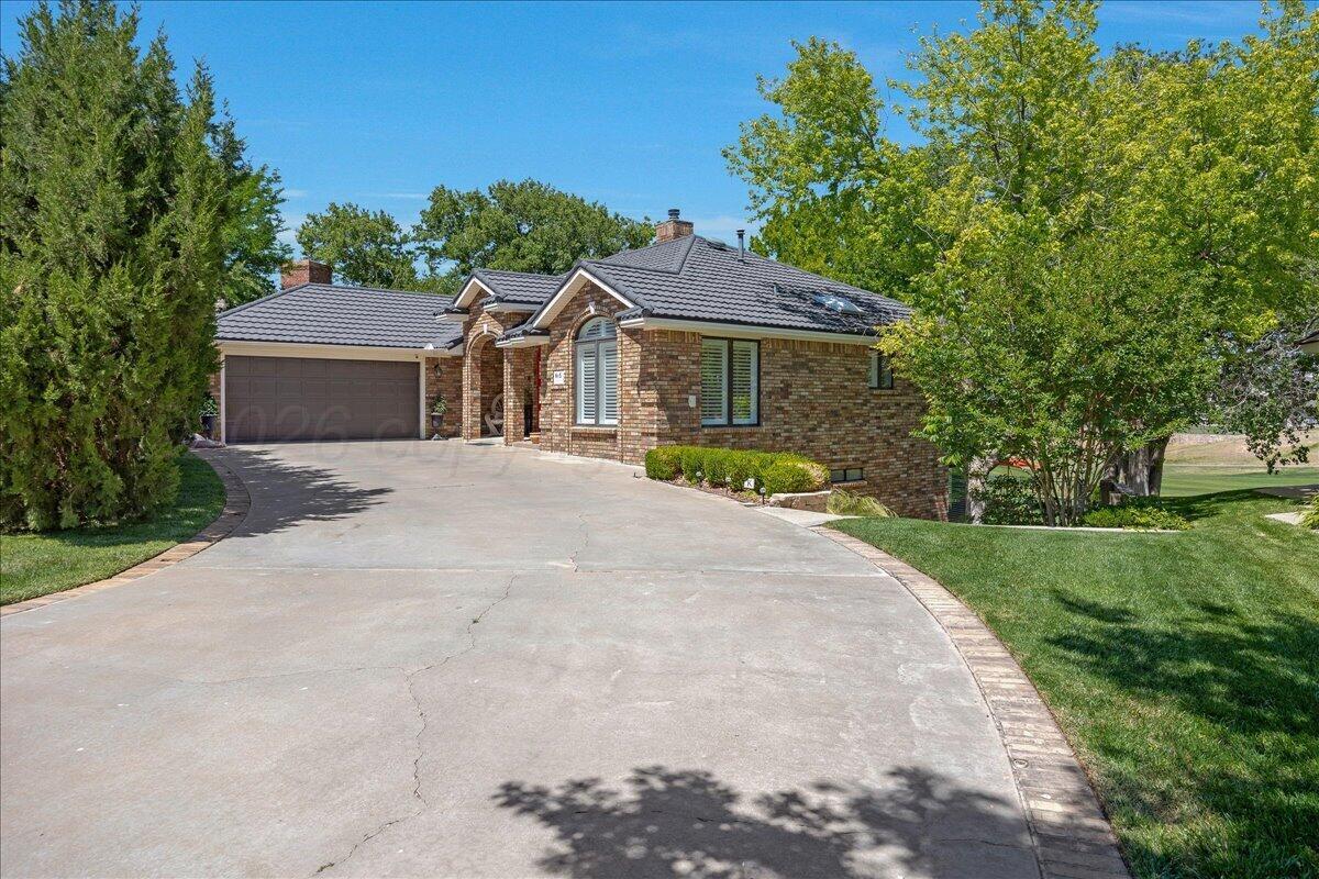 5 Locke Place Amarillo, TX 79124 - Photo 2 of 53 a front view of a house with a garden and yard
