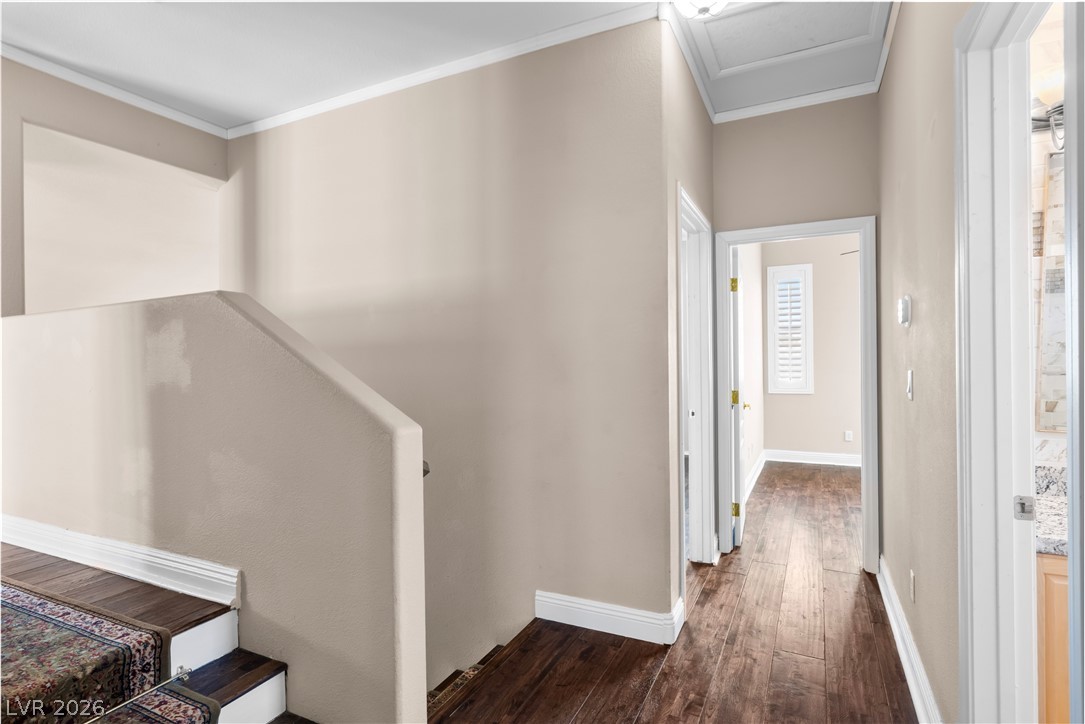 708 Vortex Avenue Henderson, NV 89002 - Photo 25 of 71 Rich hardwood floors welcome you into this well-lit hallway with elegant crown molding.