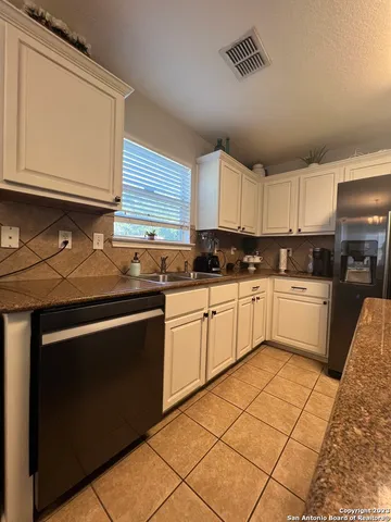 a kitchen with cabinets appliances and a sink