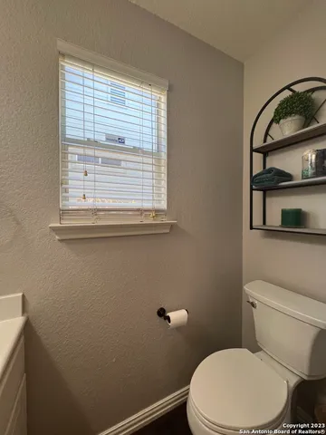 a white toilet sitting next to a window