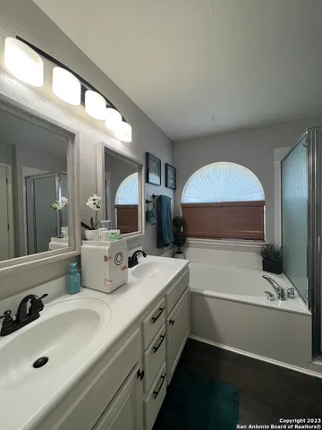 a bathroom with a double vanity sink and mirror