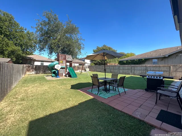 a view of a yard with furniture and a slide
