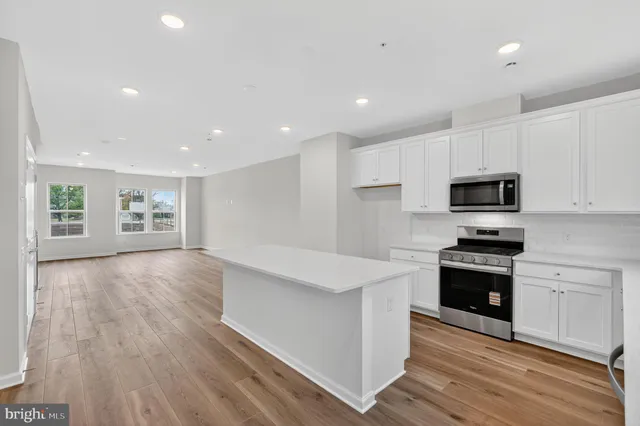 a view of kitchen with sink and microwave