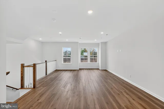 a view of a room with wooden floor and window