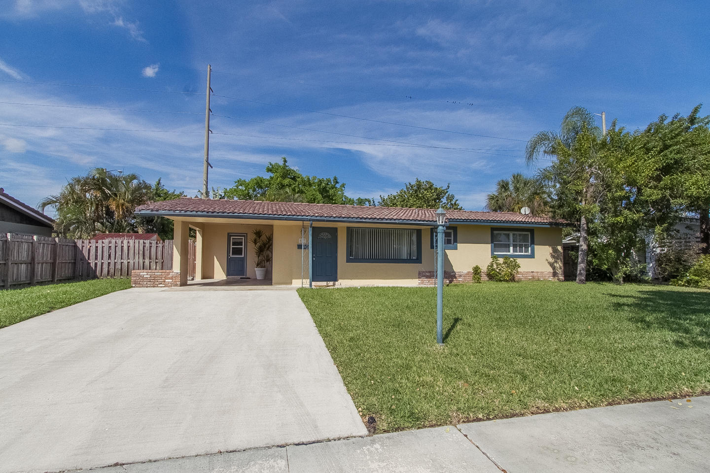 a front view of house with a garden