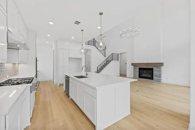 a view of an empty room with a window and chandelier
