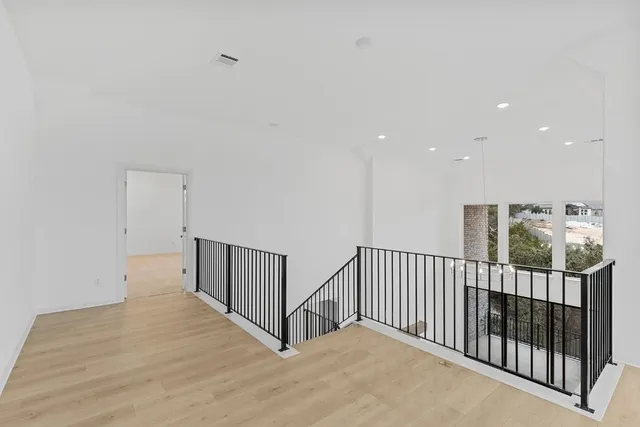 a view of empty room with window and ceiling fan