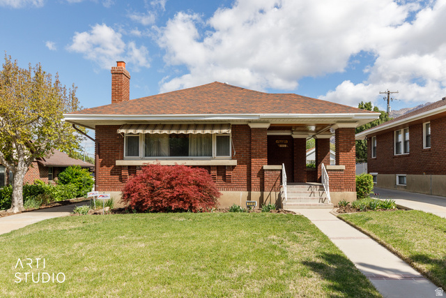 1110 23rd Street Ogden, UT 84401 - Photo 1 of 1 Bungalow-style house with a front lawn, a chimney, covered porch, brick siding, and a shingled roof