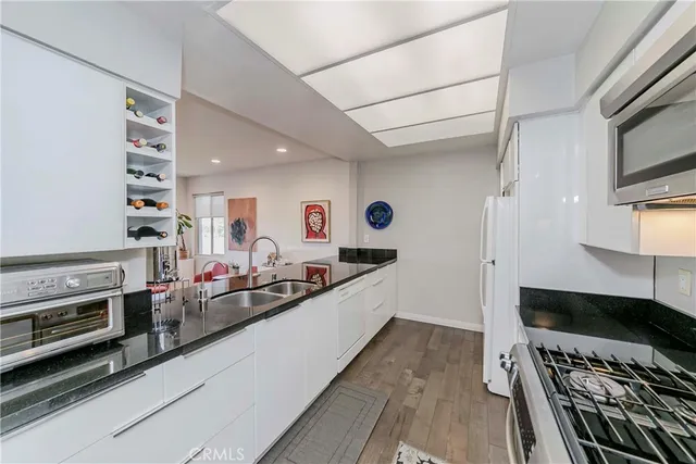 a large kitchen with stainless steel appliances a stove and a refrigerator