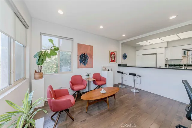 a living room with furniture and a kitchen