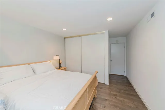 a bedroom with a bed and a painting on the wall