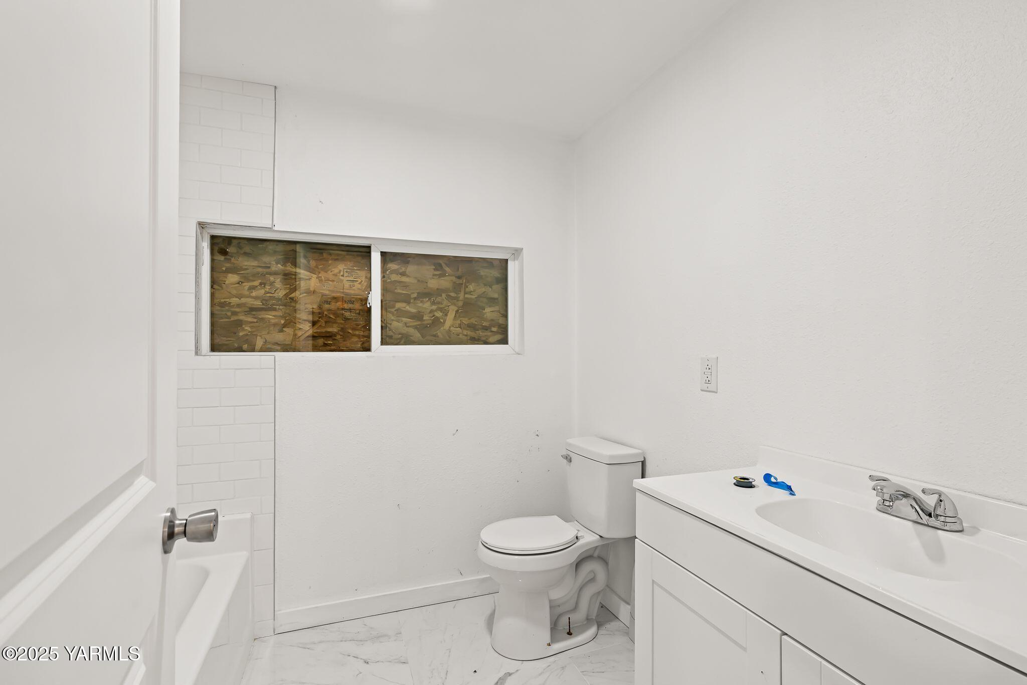 810 North 6th Avenue Yakima, WA 98902 - Photo 8 of 10 a white toilet sitting next to a bathroom sink