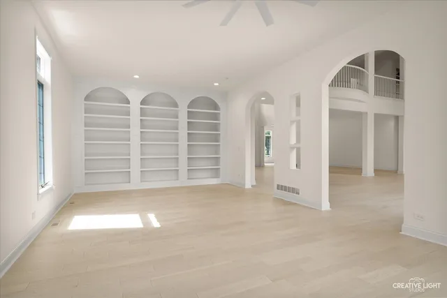a view of an empty room with a fireplace and a window
