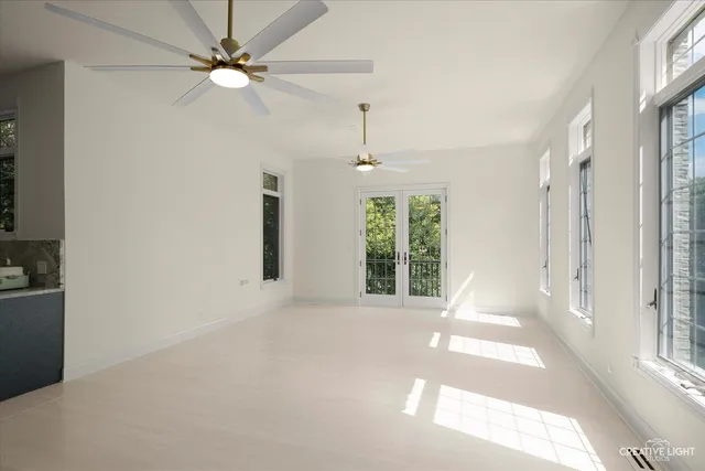 a view of a hallway with wooden floor and windows