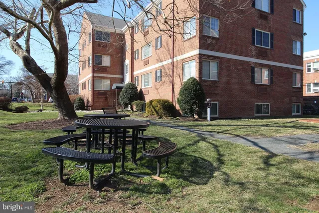 a view of a brick building with a table and chairs in it