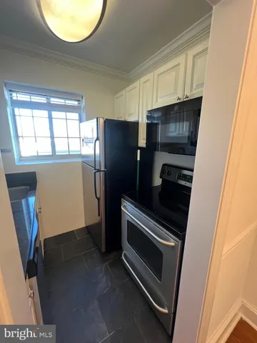 a kitchen with appliances and a window
