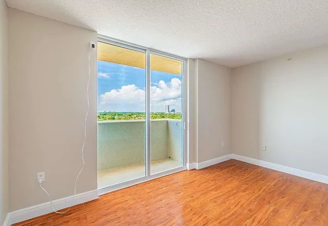 a view of an empty room with glass door