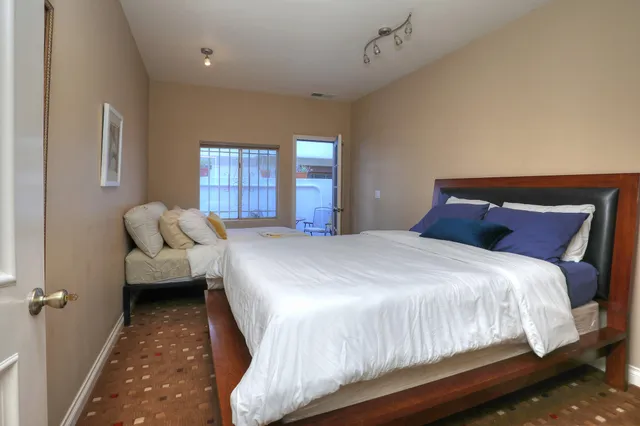 a bedroom with a bed and a window