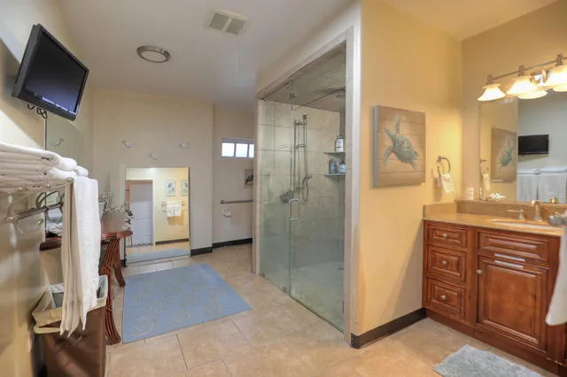 a bathroom with a double sink shower and a mirror
