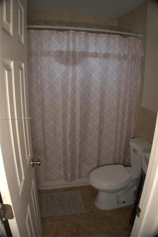 a white toilet sitting next to a sink
