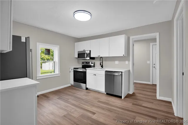 a kitchen with granite countertop a refrigerator and a stove
