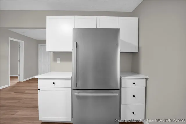 a kitchen with refrigerator a stove and a refrigerator
