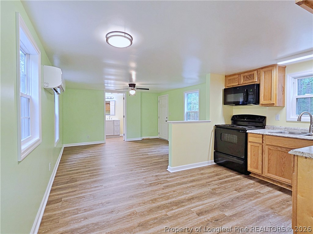 1031 Pine Acres Road White Oak, NC 28399 - Photo 6 of 29 a kitchen with a refrigerator and a stove top oven