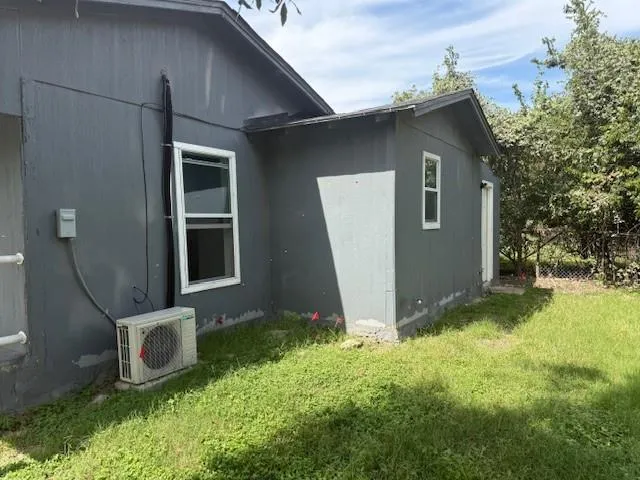 a view of backyard with barbeque grill and potted plants