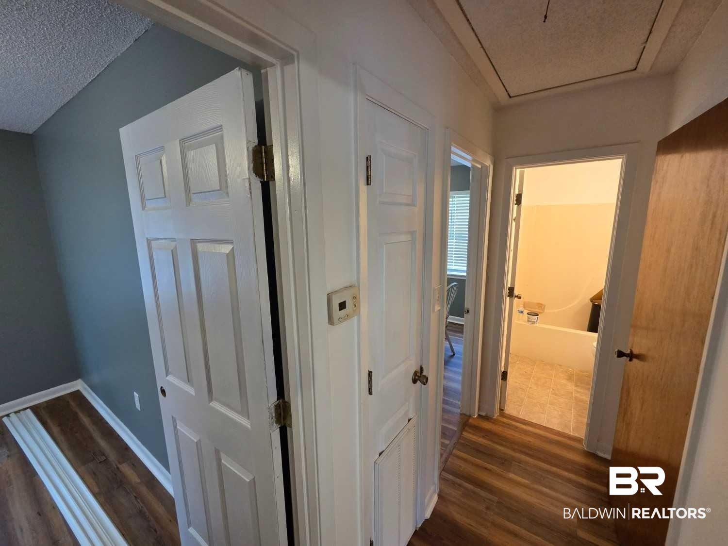 106 West 16th Street Bay Minette, AL 36507 - Photo 14 of 19 Corridor featuring dark wood-style flooring and baseboards