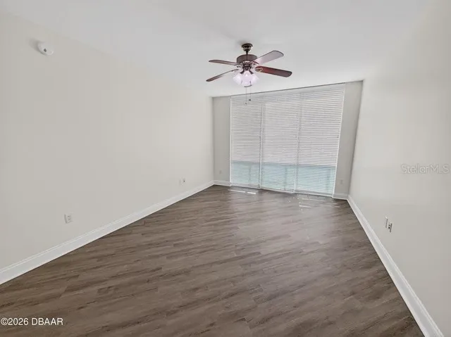 a spacious bathroom with a tub shower and checkered floor