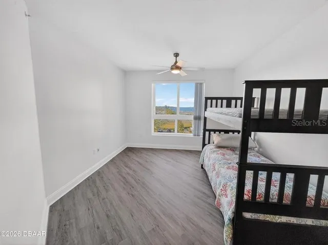 a view of a workspace with furniture and wooden floor