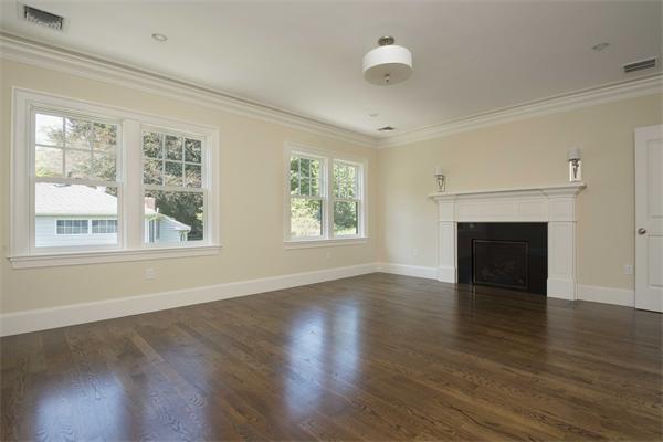 14 Hastings Road Lexington, MA 02421 - Photo 20 of 26 an empty room with wooden floor fireplace and windows