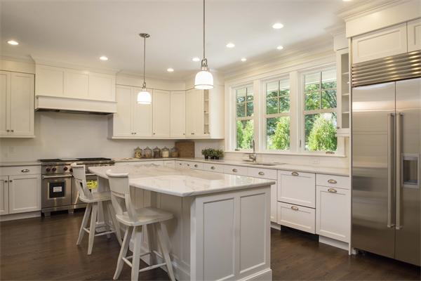 14 Hastings Road Lexington, MA 02421 - Photo 6 of 26 a kitchen with a stove a sink a kitchen island and stainless steel appliances