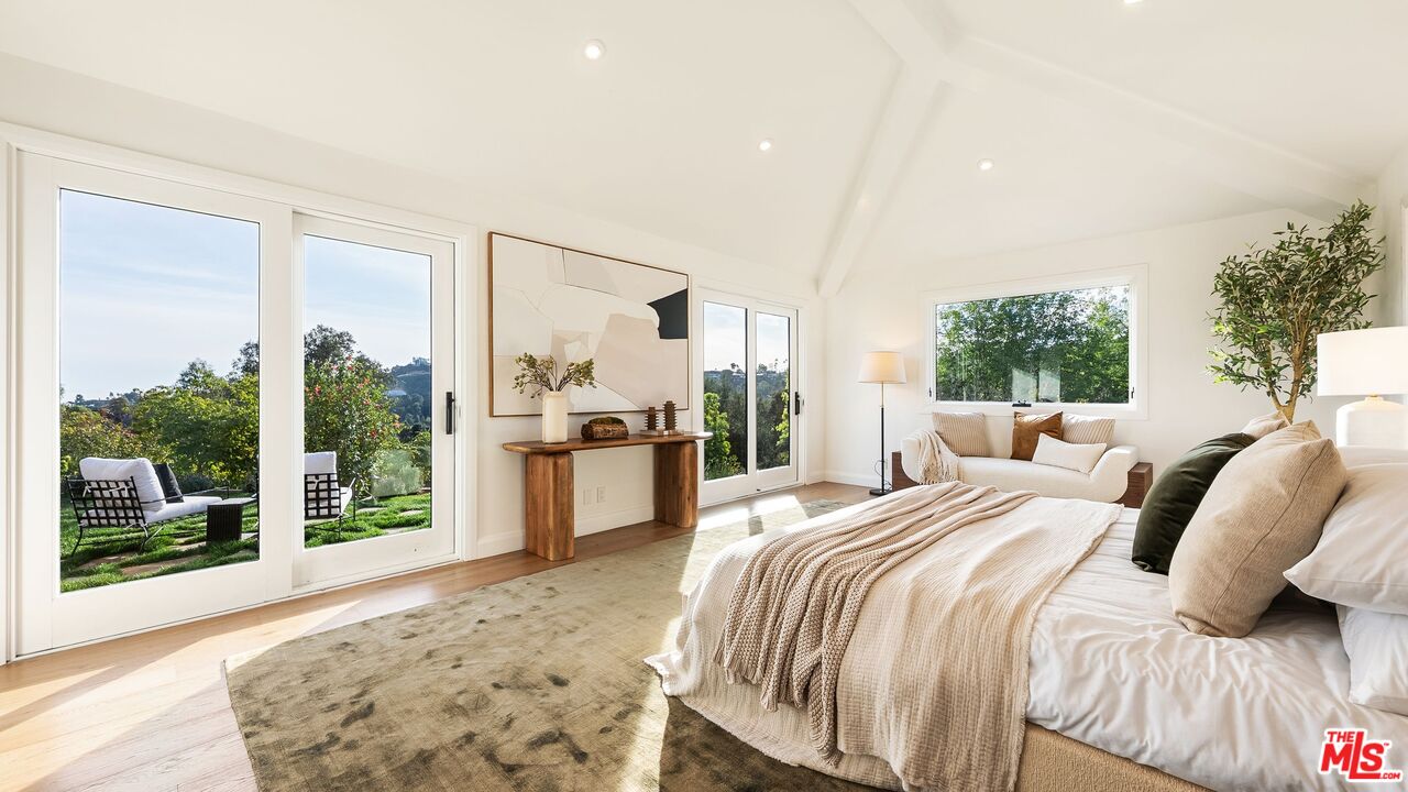 13146 Rivers Road Los Angeles, CA 90049 - Photo 15 of 42 a bedroom with a bed and a large window with outer view
