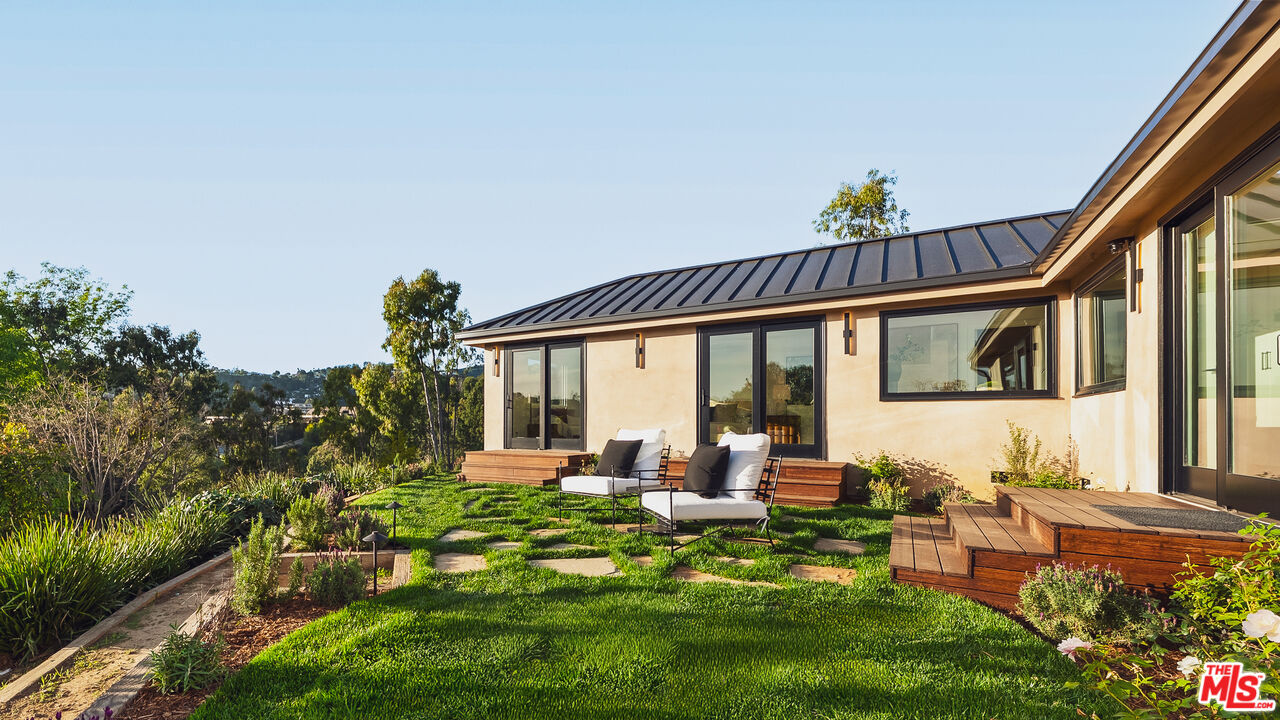 13146 Rivers Road Los Angeles, CA 90049 - Photo 16 of 42 a view of an house with backyard porch and furniture