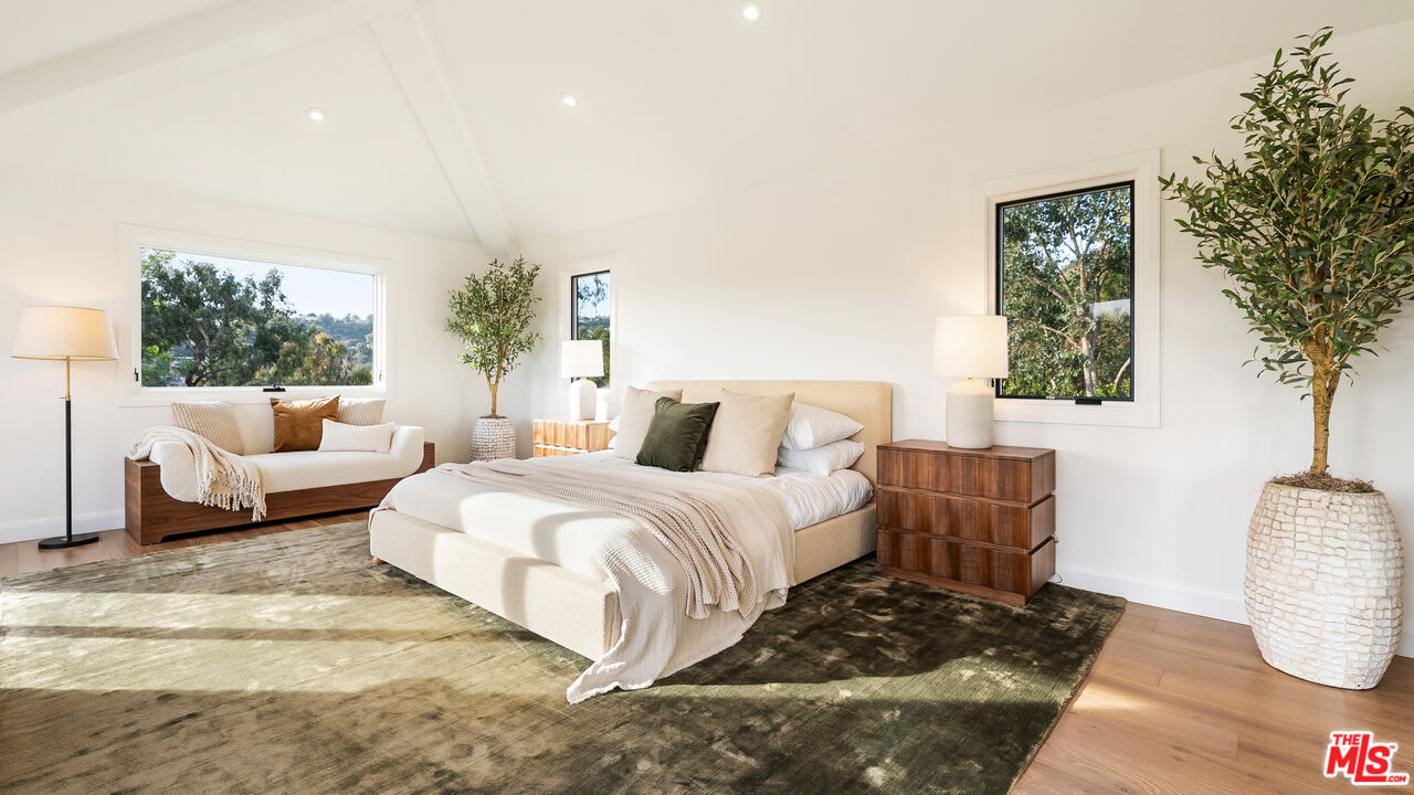 13146 Rivers Road Los Angeles, CA 90049 - Photo 17 of 42 a bedroom with furniture and a potted plant