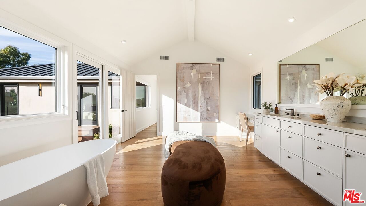 13146 Rivers Road Los Angeles, CA 90049 - Photo 19 of 42 a large bathroom with double vanity sinks a large mirror and a shower