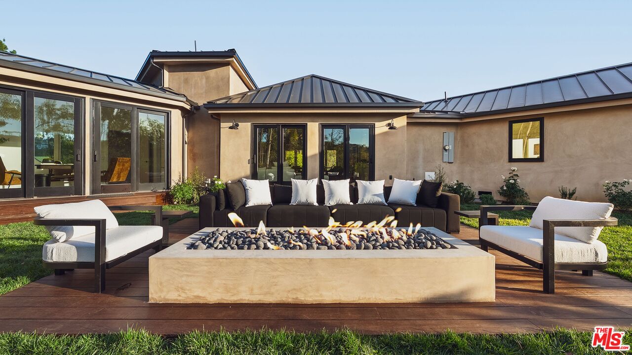13146 Rivers Road Los Angeles, CA 90049 - Photo 2 of 42 a view of a house with backyard porch and sitting area
