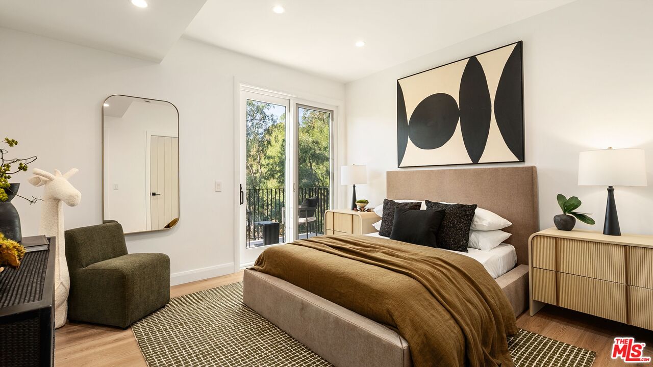 13146 Rivers Road Los Angeles, CA 90049 - Photo 27 of 42 a bedroom with a bed and glass window