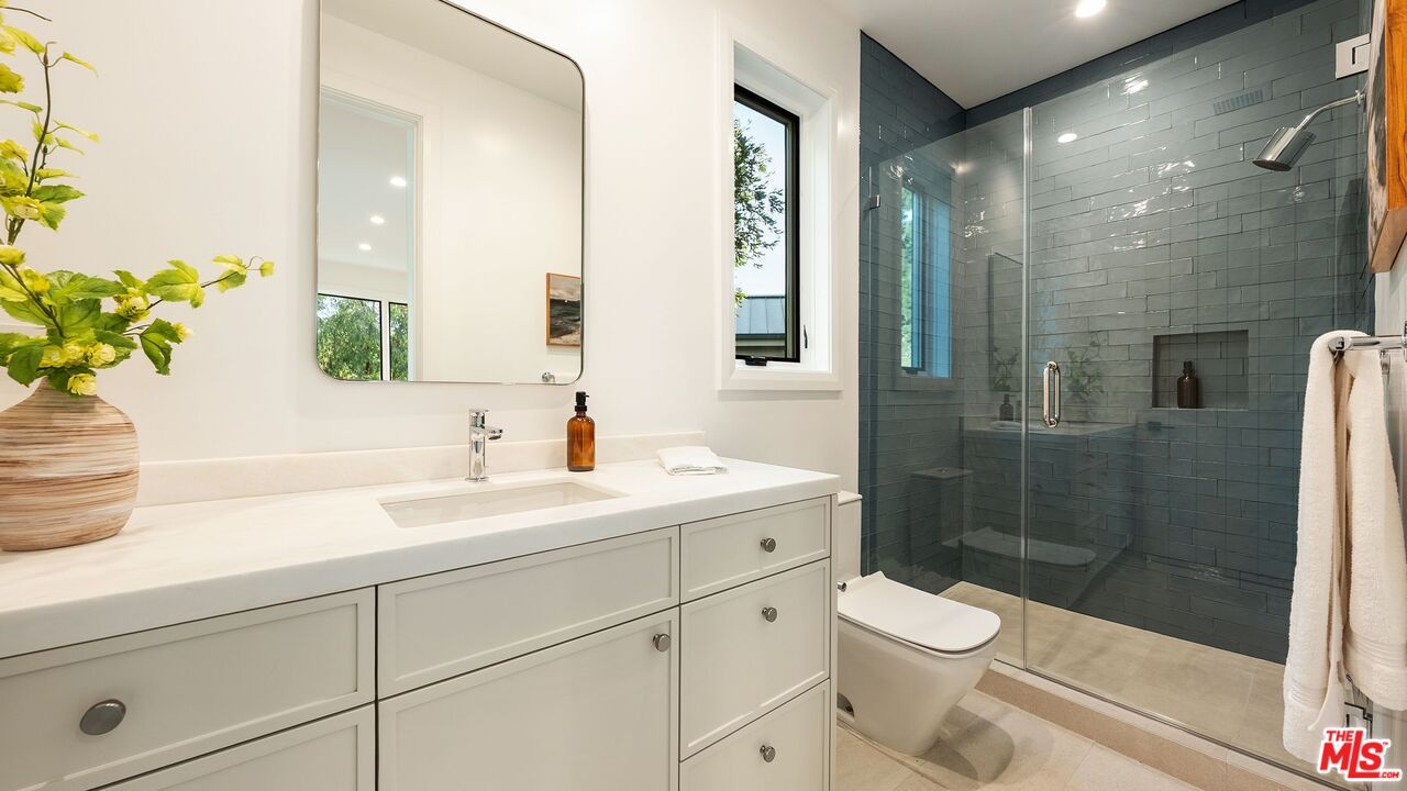 13146 Rivers Road Los Angeles, CA 90049 - Photo 31 of 42 a bathroom with a sink a toilet and shower